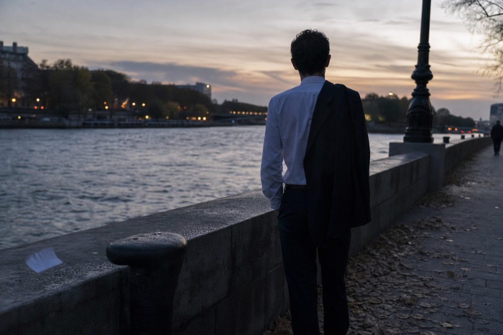 Smart casual evening outfit on a Paris riverside quay at dusk, no text, no logos, no people.