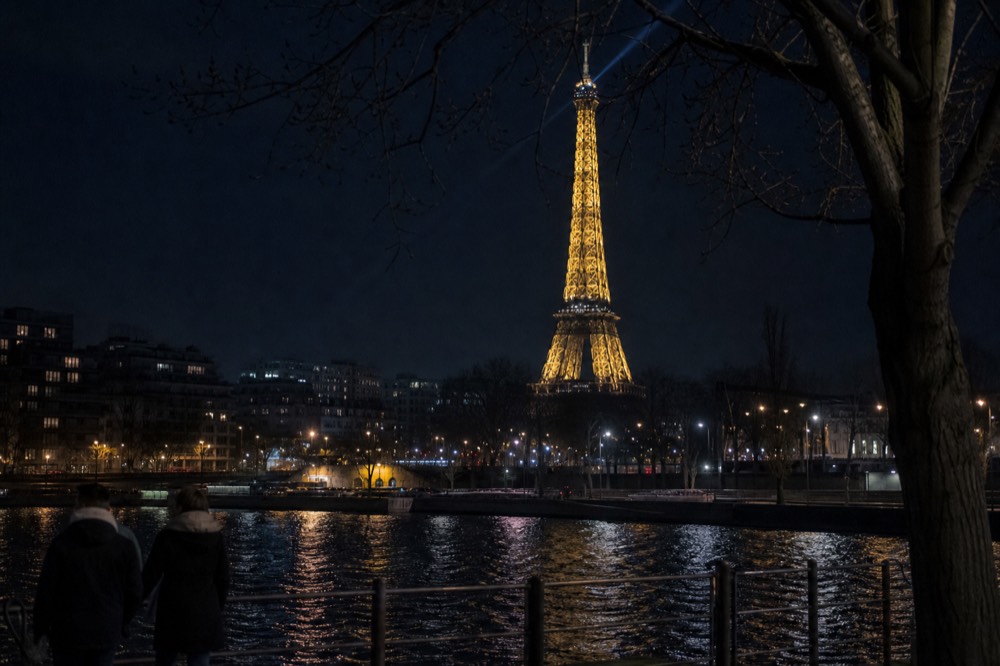 The Eiffel Tower sparkling at night above the Seine, no text, no logos, no people