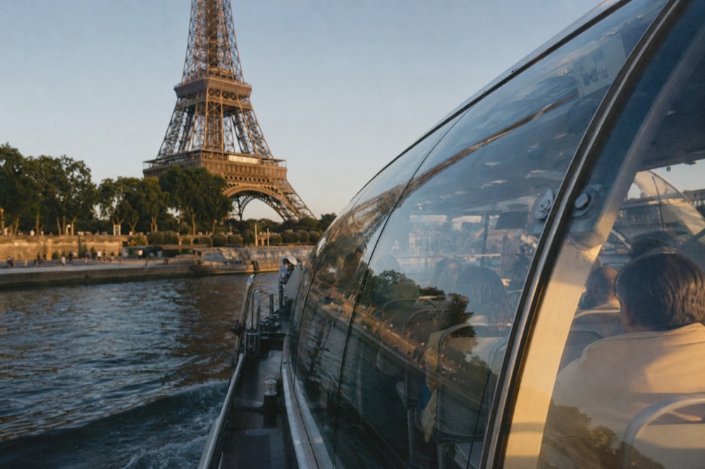 Bateaux Parisiens glass boat on the Seine with Eiffel Tower in background, no text, no logos, no people