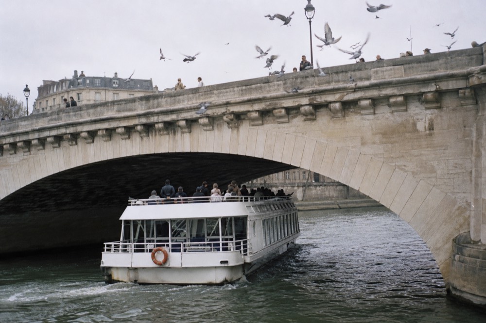 Seine river with tour boat and historic bridges, no text, no logos, no people