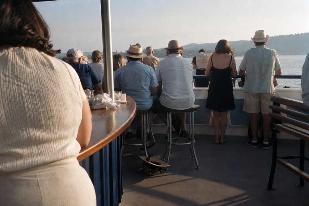 A busy Seine cruise boat upper deck in late afternoon, no text, no logos, no people