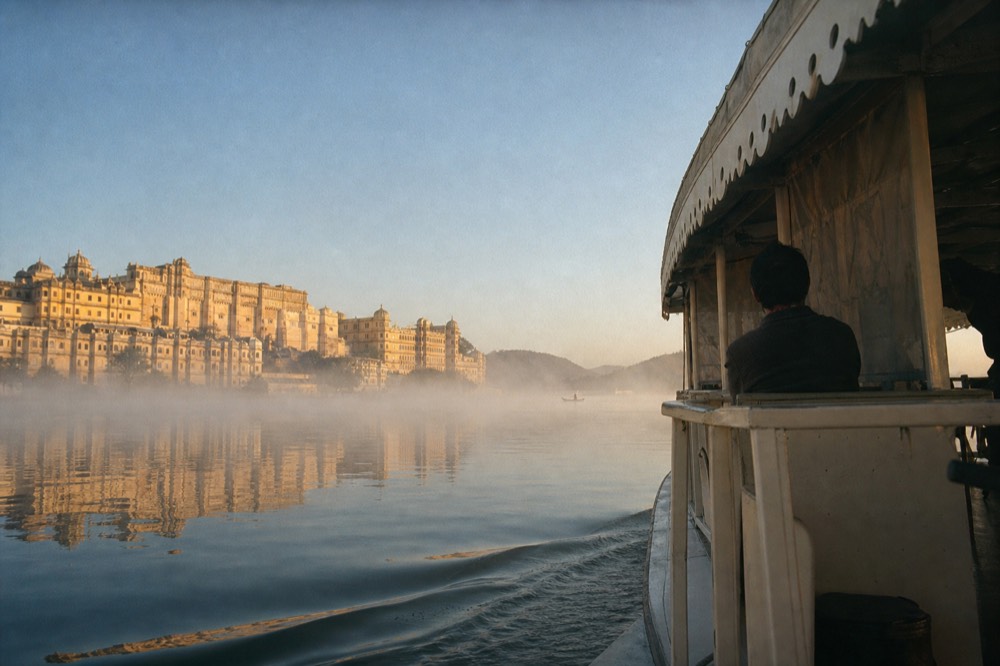 A Seine cruise boat on calm morning water with soft light on Parisian buildings, no text, no logos, no people
