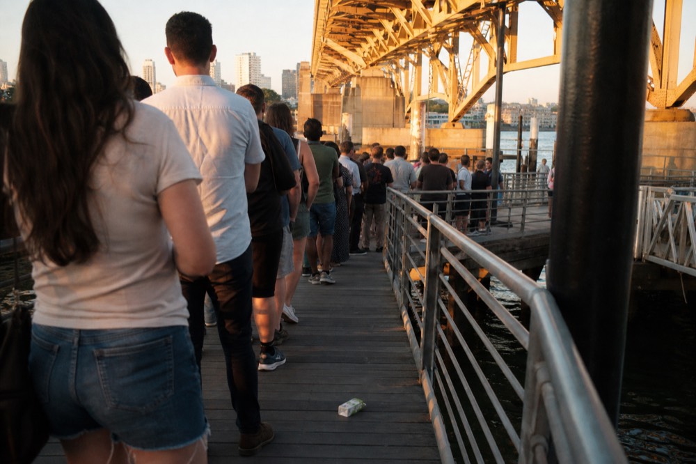 Queue of visitors waiting at a Seine cruise boarding pontoon, no text, no logos, no people