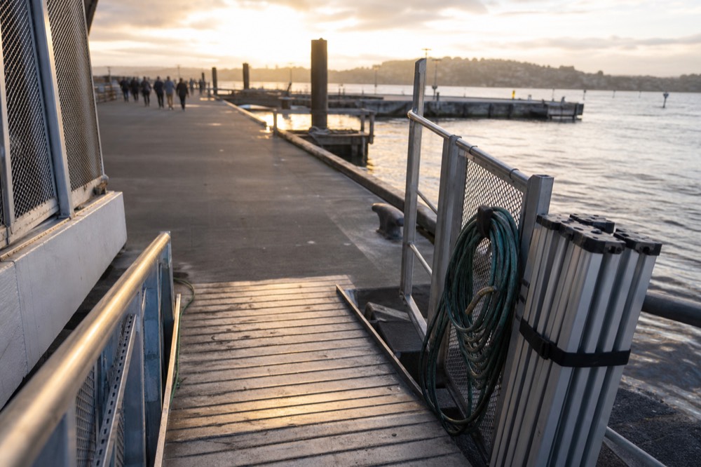 Cruise boat gangway and boarding gate on a Seine quay in late afternoon, no text, no logos, no people