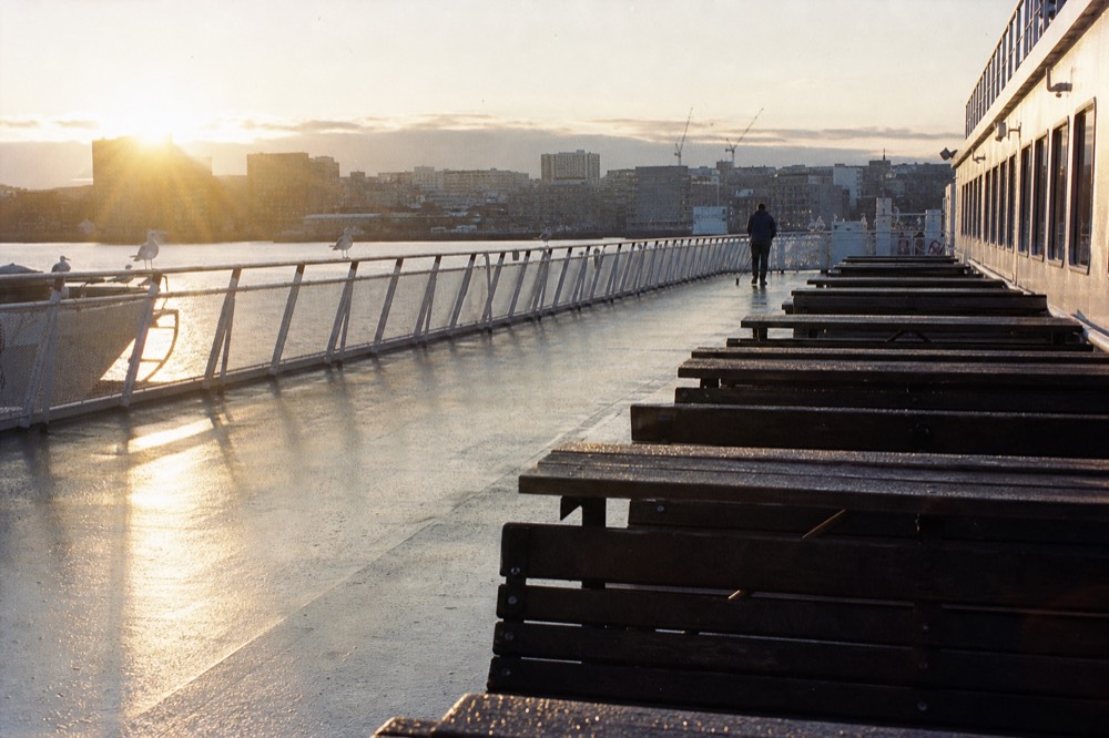 Empty morning deck of a cruise boat with soft light on the Seine, no text, no logos, no people